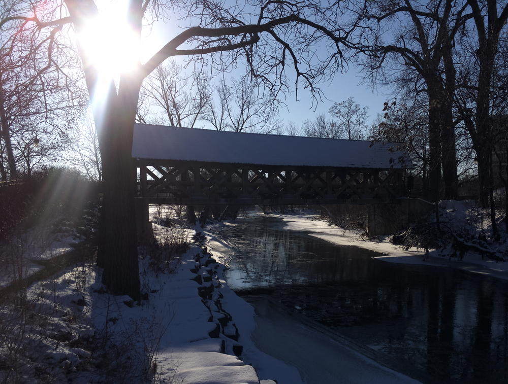 Photo of covered bridge, sun, snow